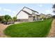 Manicured backyard with a fire pit and covered patio, perfect for outdoor entertaining and relaxation at 23421 E Rockinghorse Pkwy, Aurora, CO 80016