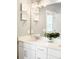 Bright bathroom featuring double vanity with quartz countertops, and framed mirrors at 23421 E Rockinghorse Pkwy, Aurora, CO 80016