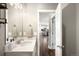 Bright bathroom with a quartz countertop, modern fixtures, and a view into the open floor plan at 23421 E Rockinghorse Pkwy, Aurora, CO 80016
