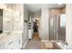 Bright bathroom with double vanity, walk-in shower, soaking tub, and walk-in closet at 23421 E Rockinghorse Pkwy, Aurora, CO 80016