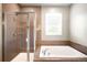 Bathroom featuring a modern shower with glass door, and a relaxing soaking tub at 23421 E Rockinghorse Pkwy, Aurora, CO 80016