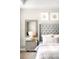 This bedroom features a tufted headboard, mirrored nightstand and complementary wall decor at 23421 E Rockinghorse Pkwy, Aurora, CO 80016