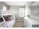 Bedroom with a bunk bed, dresser, and natural light streaming through the window at 23421 E Rockinghorse Pkwy, Aurora, CO 80016
