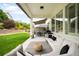Inviting covered patio with comfortable seating, outdoor grill, and views of the landscaped yard at 23421 E Rockinghorse Pkwy, Aurora, CO 80016