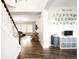 Inviting entryway with wood floors, stairway, adjacent playroom with alphabet wall art, and open living space at 23421 E Rockinghorse Pkwy, Aurora, CO 80016