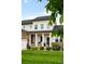 Inviting two-story home with classic white siding, stone accents, and a cozy front porch at 23421 E Rockinghorse Pkwy, Aurora, CO 80016