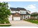 Stylish two-story home with stone accents, a well-kept lawn, and an attached three-car garage at 23421 E Rockinghorse Pkwy, Aurora, CO 80016