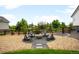 Backyard fire pit area with gravel, chairs, and wooden fence at 23421 E Rockinghorse Pkwy, Aurora, CO 80016