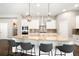 Gourmet kitchen featuring a large island, stainless steel appliances, and pendant lighting at 23421 E Rockinghorse Pkwy, Aurora, CO 80016