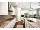 Spacious kitchen featuring white cabinets, granite countertops, and modern stainless steel appliances at 23421 E Rockinghorse Pkwy, Aurora, CO 80016