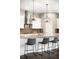 Modern kitchen with white cabinets, stainless steel appliances, granite countertops, and a sleek range hood at 23421 E Rockinghorse Pkwy, Aurora, CO 80016