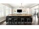 Stylish living room with dark wood floors, a large TV, and a unique sofa bar at 23421 E Rockinghorse Pkwy, Aurora, CO 80016