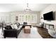 Open living room boasts large windows, modern decor, and a comfortable leather sectional at 23421 E Rockinghorse Pkwy, Aurora, CO 80016