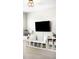 A loft with bookshelves, and built in seating under a large tv provides a cozy space for relaxing at 23421 E Rockinghorse Pkwy, Aurora, CO 80016