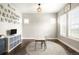 A playroom with hardwood floors, alphabet wall art, storage shelves, and natural light from large windows at 23421 E Rockinghorse Pkwy, Aurora, CO 80016