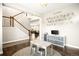 A playroom with stairway access and alphabet wall art and hardwood floors leading into adjacent living room space at 23421 E Rockinghorse Pkwy, Aurora, CO 80016