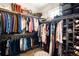 Organized walk-in closet featuring ample storage and custom shelving at 23421 E Rockinghorse Pkwy, Aurora, CO 80016