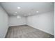 Spacious finished basement with neutral carpet, recessed lighting, and a small window at 1809 W Crestline Dr, Littleton, CO 80120
