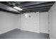 Unfinished basement with painted floor, window, and exposed ceiling, providing potential for customization and additional living space at 1809 W Crestline Dr, Littleton, CO 80120