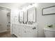 Double vanity with stylish mirrors in a bright bathroom with updated fixtures at 1809 W Crestline Dr, Littleton, CO 80120