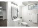Modern bathroom with white vanity, updated fixtures, framed mirror and neutral tiling, offering a clean and stylish space at 1809 W Crestline Dr, Littleton, CO 80120