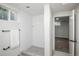 The bright bathroom features a glass-enclosed shower, white subway tile and a neutral floor at 1809 W Crestline Dr, Littleton, CO 80120