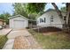 Detached garage next to a charming home, connected by a covered area and mulch landscaping at 1809 W Crestline Dr, Littleton, CO 80120