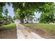 Charming home featuring a detached garage, lush lawn, and mature trees enhancing its curb appeal at 1809 W Crestline Dr, Littleton, CO 80120