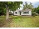 Well-kept single-Gathering home featuring a lush green lawn, mature trees, and inviting curb appeal at 1809 W Crestline Dr, Littleton, CO 80120