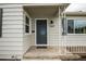Close-up of the front entrance featuring a stylish door, updated fixtures, and clear house numbers at 1809 W Crestline Dr, Littleton, CO 80120