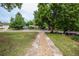 Inviting front yard with rock-lined walkway and mature trees adding to the home's curb appeal at 1809 W Crestline Dr, Littleton, CO 80120