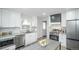 Updated kitchen featuring stainless steel appliances, white cabinets, and stylish countertops at 1809 W Crestline Dr, Littleton, CO 80120