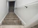 Carpeted stairway with white railing leading to the lower level of the home at 1809 W Crestline Dr, Littleton, CO 80120