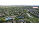 Wide aerial view showcasing a vibrant neighborhood with a pool, tennis courts, and lush greenery at 20145 E Fair Ln, Centennial, CO 80016