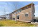 This backyard has a grill on the patio, a small grass area, and wood-look siding at 20145 E Fair Ln, Centennial, CO 80016