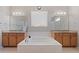 Bright bathroom featuring a soaking tub with separate vanities and a large window at 20145 E Fair Ln, Centennial, CO 80016