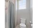 Bathroom with a shower, a toilet, and natural light from a window at 20145 E Fair Ln, Centennial, CO 80016