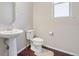Powder room featuring a pedestal sink and toilet at 20145 E Fair Ln, Centennial, CO 80016