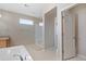 Bright bathroom with a glass shower, a window, and a neutral color scheme at 20145 E Fair Ln, Centennial, CO 80016