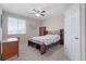 Comfortable bedroom with a ceiling fan, a wooden bed frame, and natural light from a window at 20145 E Fair Ln, Centennial, CO 80016