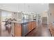 Open concept kitchen featuring an island, stainless steel appliances, and hardwood floors at 20145 E Fair Ln, Centennial, CO 80016