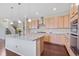 Charming kitchen featuring an island, stainless steel appliances, and wooden cabinetry at 20145 E Fair Ln, Centennial, CO 80016