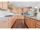 Modern kitchen with light wood cabinets, stainless steel appliances, and a granite countertops at 20145 E Fair Ln, Centennial, CO 80016