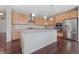 Charming kitchen featuring an island, stainless steel appliances, and wooden cabinetry at 20145 E Fair Ln, Centennial, CO 80016