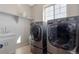 Laundry room with white cabinets, stainless steel washer and dryer at 20145 E Fair Ln, Centennial, CO 80016