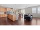 Living room and dining room with hardwood floors open to kitchen island with granite countertops at 20145 E Fair Ln, Centennial, CO 80016