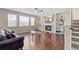 Bright living room featuring a cozy fireplace, custom built-in shelving, and large windows at 20145 E Fair Ln, Centennial, CO 80016