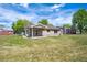 View of house exterior with big backyard, patio, and covered back porch at 9214 Winona Ct, Westminster, CO 80031