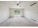 Bright, carpeted bedroom with large window offering ample natural light and backyard views at 9214 Winona Ct, Westminster, CO 80031