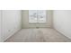 Neutral carpeted room illuminated by natural light from a large window at 9214 Winona Ct, Westminster, CO 80031